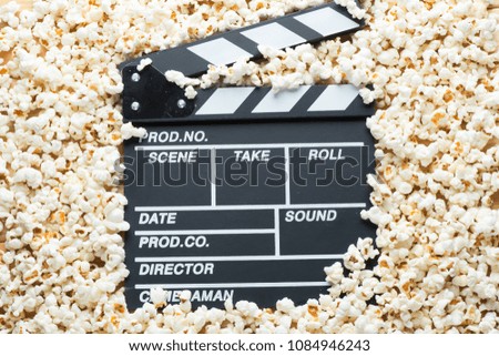video clapper for shooting a movie on a background of popcorn close up