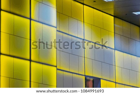 Yellow and white glass made interior wall of a large modern shopping mall isolated unique stock photo