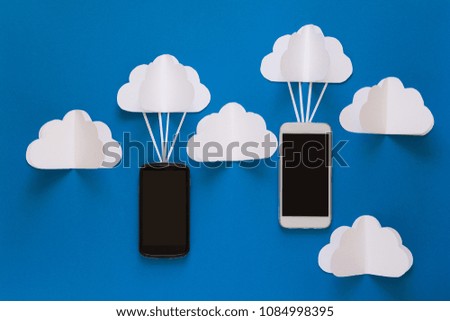 Network connection and cloud storage technology concept. Data communications and cloud computing network concept. Smart phone flying on paper cloud. Origami. Paper cut. Top view