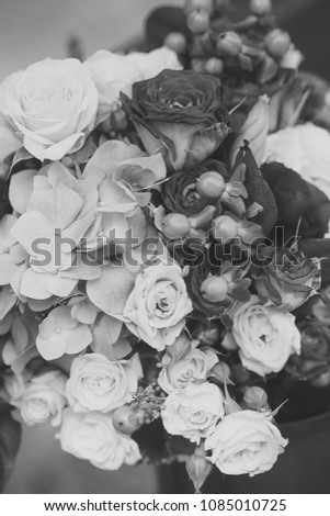 Closeup of beautiful fresh colorful summer bouquet of cut flowers with red and white roses voilet hydrangea and green buds, vertical picture