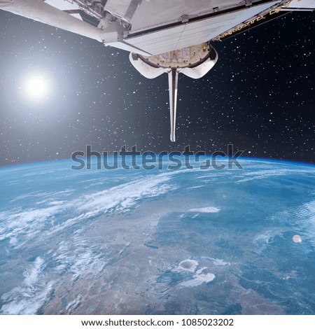 Spaceship (shuttle) flying from earth. The elements of this image furnished by NASA.