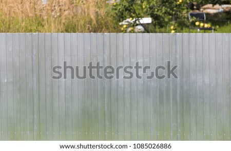 Metal fence on the cottage site as a background