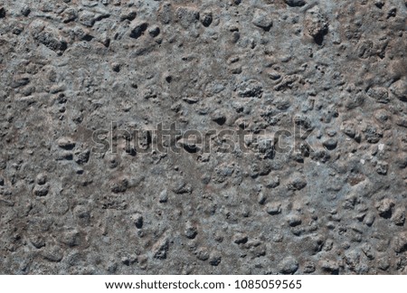 Grey concrete background with small holes and scratches. Abstract cement texture.