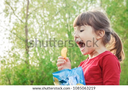 child eats chips. selective focus. 