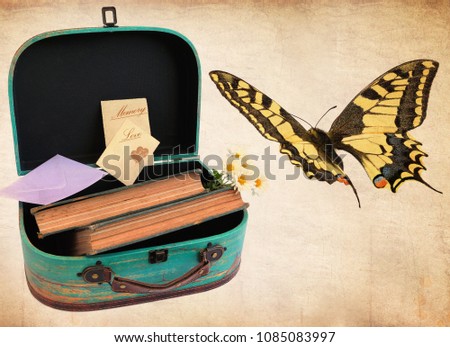 Vintage suitcase with old books, bunch of white flowers, letter in envelope and old postcards with the words Love and Memory. Postage wax seal with Love and heart shapes. Butterfly flies. Retro style