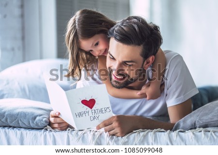 I love you, dad! Handsome young man at home with his little cute girl. Happy Father's Day! Royalty-Free Stock Photo #1085099048