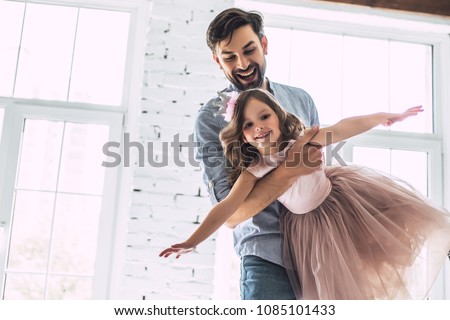 I love you, dad! Handsome young man is dancing at home with his little cute girl. Happy Father's Day! Royalty-Free Stock Photo #1085101433