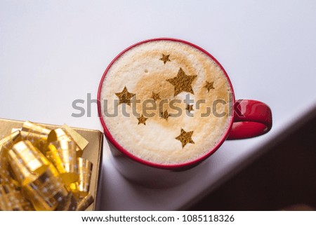 cappuccino with a picture of stars and red roses