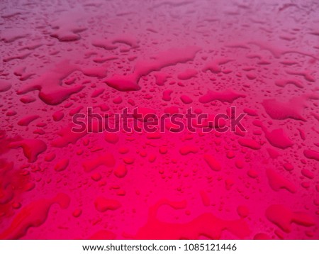 Blurred close up rain drop on the red floor, selective focus