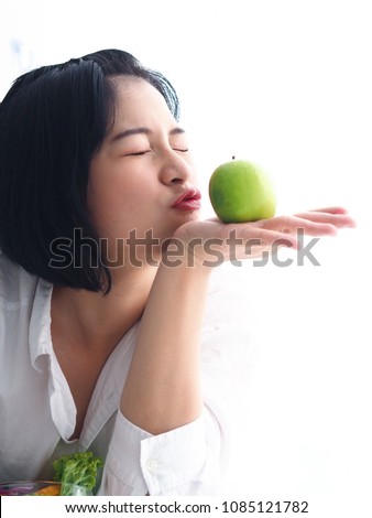 Asian woman eating fresh vegetables salad in the morning.