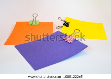 orange, purple and yellow note stickers with foldback clips isolated