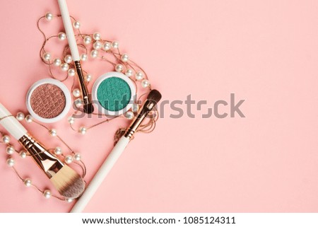 Brushes and shadow for make-up, pink background, free place                           
