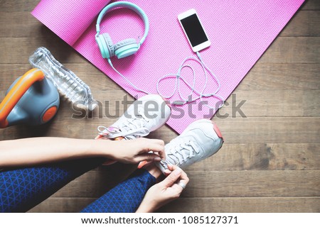 Sport and healthy woman tying her shoes, Workout at home, Wellbeing Royalty-Free Stock Photo #1085127371