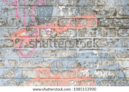 Abstract background of peeling paint on a brick wall, old colorful paint with cracks 