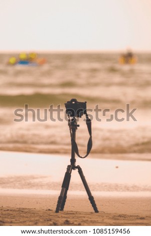 carbon fiber tripod with digital single lens reflect on the beach