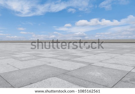 Empty square floor tiles and beautiful sky landscape
