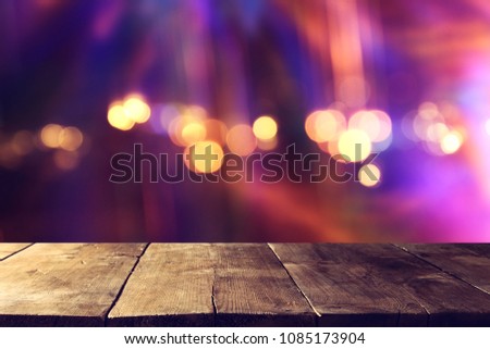 Empty table in front of glitter lights background. For product display montage