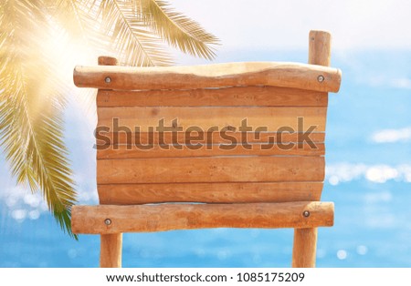 image of wooden sign in front of tropical sea landscape