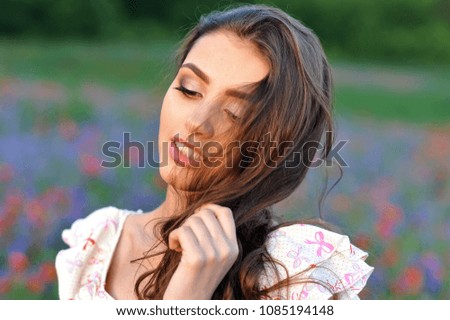 Young woman relax on the poppies plantation in summer time