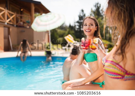 Group of friends partying in pool