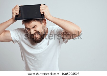  a man with emotions on his face with a tablet on his head                              
