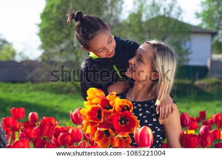 Happy family in the red and yellow tulips field