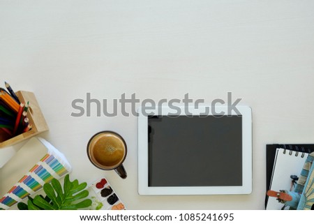 Graphic designer desk essentials with wooden texture background. Top view shot
