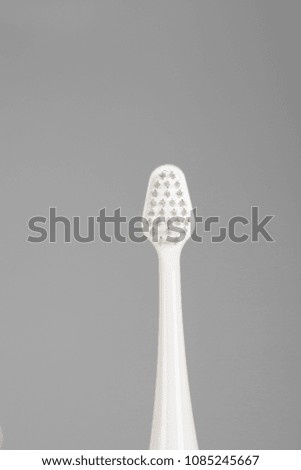 Ultrasonic toothbrush on a gray background. Closeup