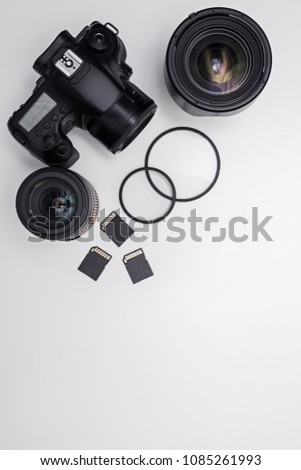 dslr camera, lenses, photo equipment and copy space over white table background
