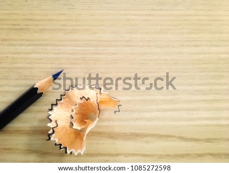 Sharpener coloring pencil on brown wood background with copy space