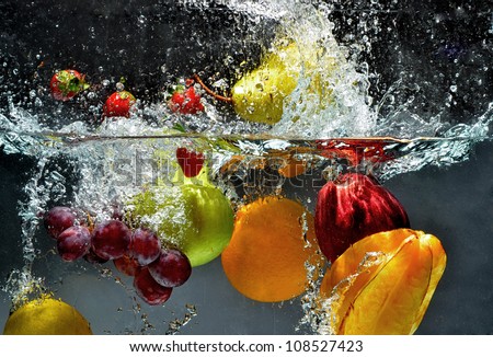 Splashing fruit on water. Fresh Fruit and Vegetables being  shot as they submerged under water.  Illustration of Washing food before being process further into a healthy and natural food Royalty-Free Stock Photo #108527423