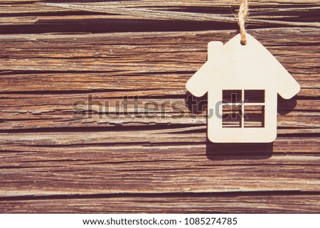 House symbol on a background of pine boards 