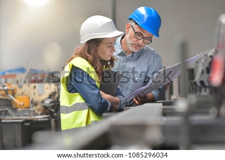 Metal industry manager and engineer meeting in factory