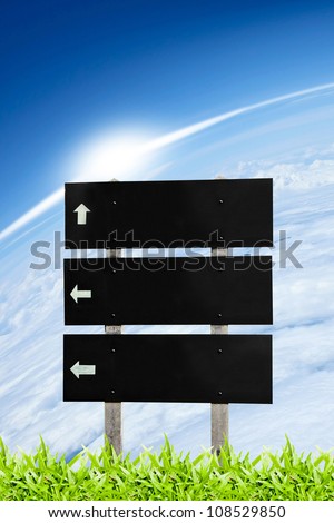 Wooden sign billboard on the grass isolated on sky cloud background