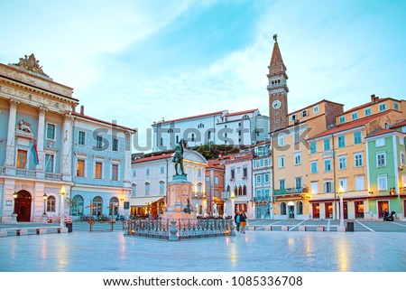Beautiful street landscape on the central square with a monument and an ancient watch tower in Piran, the tourist center of Slovenia. Royalty-Free Stock Photo #1085336708
