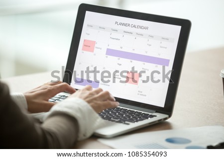 Businesswoman planning day using digital planner or calendar software application on laptop screen, employee making event schedule with personal organizer, time management concept, close up view Royalty-Free Stock Photo #1085354093