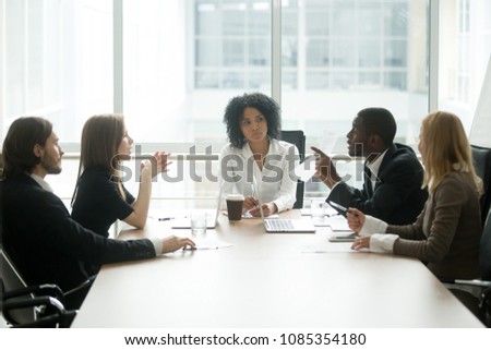 Multiracial people having dispute about bad document at group meeting, african businessman disagreeing with contract terms at multi-ethnic negotiations in lawyers office, fraud or legal fight concept Royalty-Free Stock Photo #1085354180