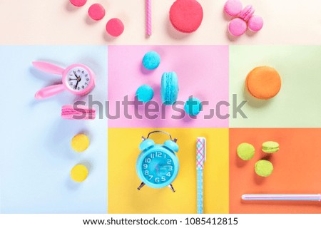 colorful macarons or macaroons dessert sweet beautiful and watch or pen with vintage pastel background.
