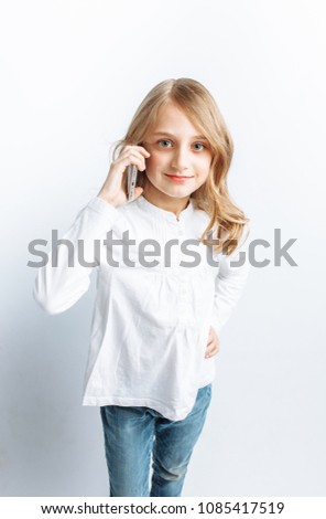 Beautiful teen girl talking on mobile phone, photo Studio
