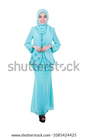 young woman wearing hijab standing over white background