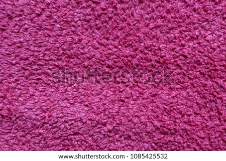 Texture of a terry towel in pink color for a bathroom flat top view
