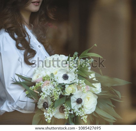 white floral bunch decorated with white roses hydrangeas and poppies