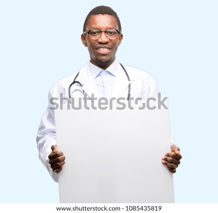 Young black doctor, medical professional holding blank advertising banner, good poster for ad, offer or announcement, big paper billboard