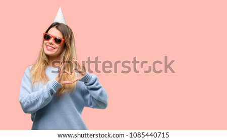 Young woman celebrates birthday happy showing love with hands in heart shape expressing healthy and marriage symbol