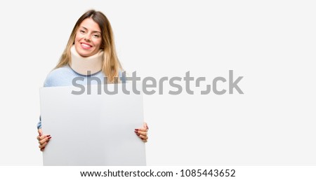 Young injured woman wearing neck brace collar holding blank advertising banner, good poster for ad, offer or announcement, big paper billboard