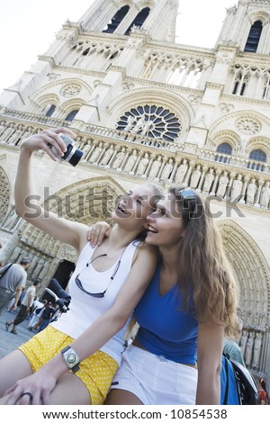 two young beautiful woman are visiting paris in summer with bicycle