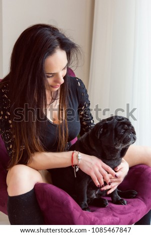 Life of pug breed dogs. Pets and woman. Girl dog lover hugging dog breed Mops