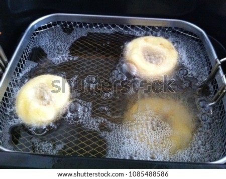 frier with donuts Royalty-Free Stock Photo #1085488586