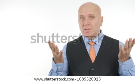 Serious Businessman Portrait Speaking and Gesturing In Meeting