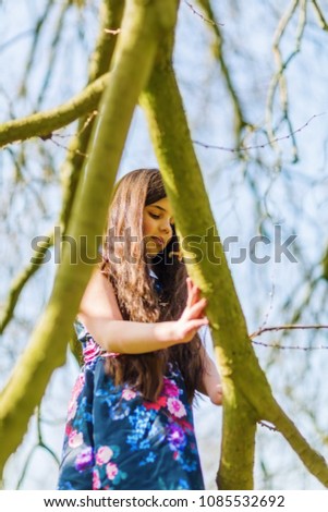 portrait picture of a young girl playing in a tree